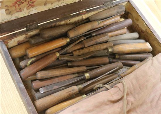 A collection of wood working tools in a wooden box